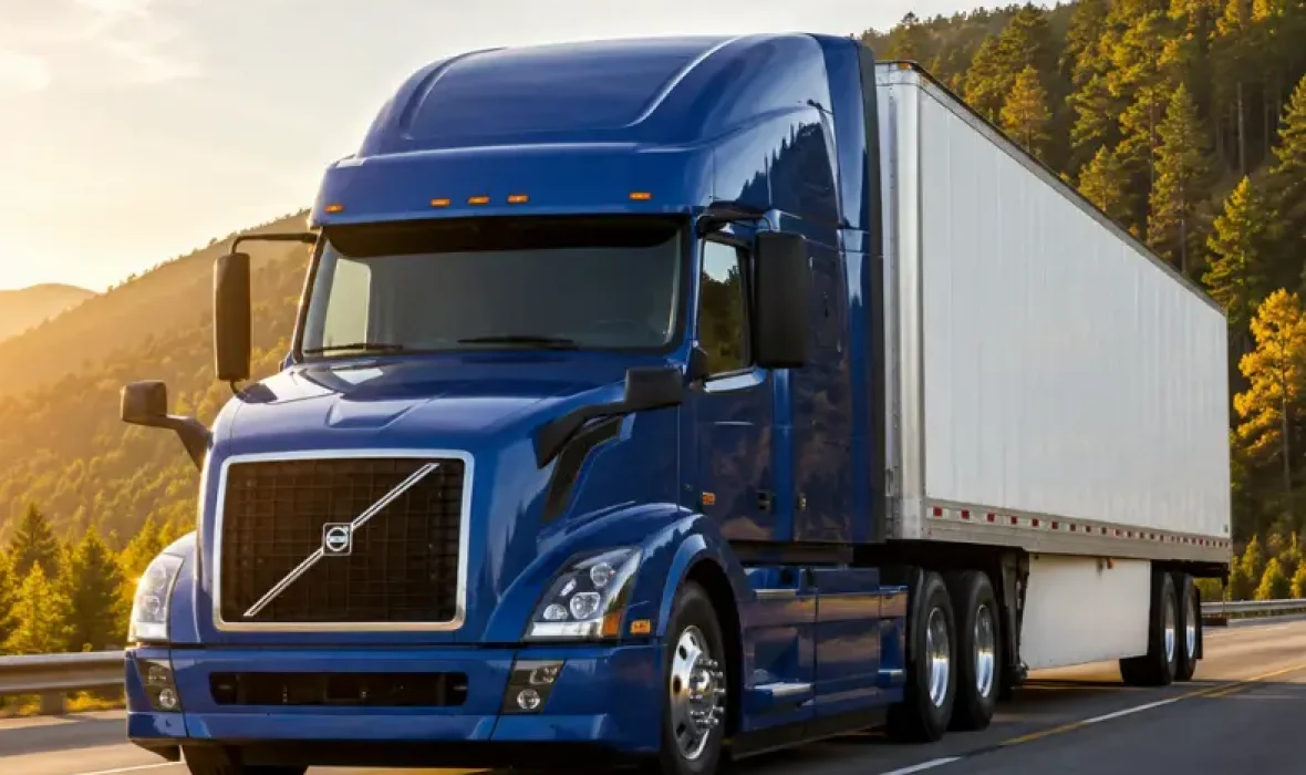 Image of truck with blue cab and white trailer on highway promoting Canadian TMS, Aviel Solutions